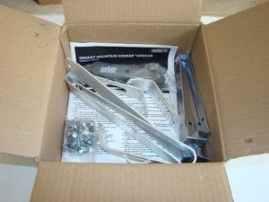 Legs, grate support straps, lid handle, hardware pack, and owner's manual