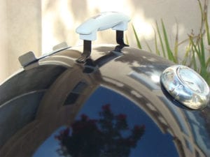 Close-up of lid handle, damper, and thermometer
