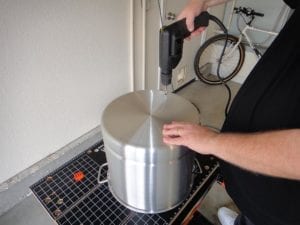Drilling a starter hole in bottom of pot
