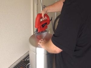 Cutting out the bottom of pot with jigsaw
