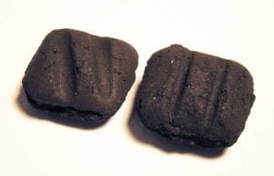 Deeper, diagonal Sure Fire Grooves (left) are pressed into each 2010 formula Kingsford briquette.