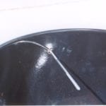 E-clip fastened to candy thermometer inside the lid