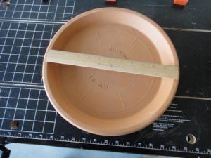 Overhead view of clay saucer with 12" ruler as a size reference