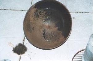 Lid with rust-colored residue before washing