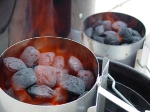 Two flaming Weber chimney starters