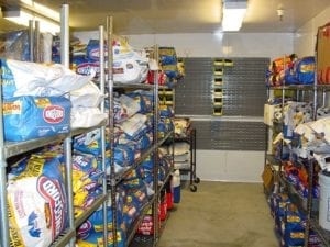 Kingsford and competitive products are stored in this climate- controlled room prior to testing. The yellow bins on the back wall contain sample briquettes from factory production runs. There were many more of these bins in other parts of the room. This photo shows half of the entire room.