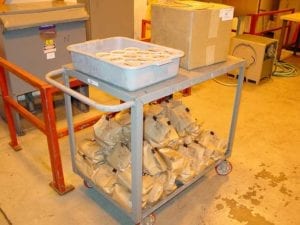 Samples of charcoal awaiting lab testing. Each container and bag is numbered for tracking purposes.