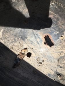 Close-up of holes in charcoal bowl, part of a propane conversion mod