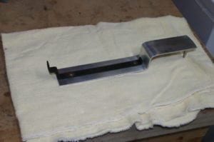 Lid hanger with long side facing down on work surface