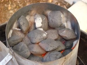 Close-up of lit charcoal in chimney starter