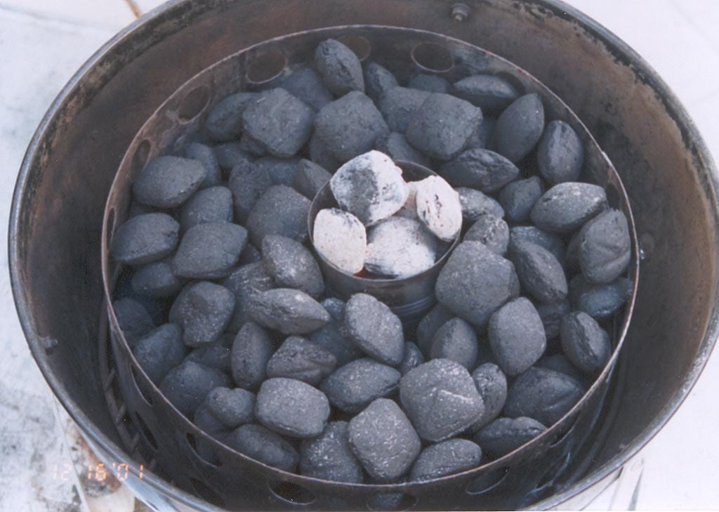Lighting briquettes using a coffee can