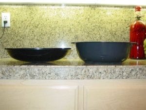 Side view of WSM water pan next to Brinkman charcoal pan