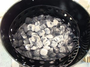 Hot coals spread over unlit briquettes