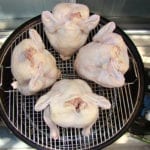 Overhead view of 4 beer can chickens on 22" top grate