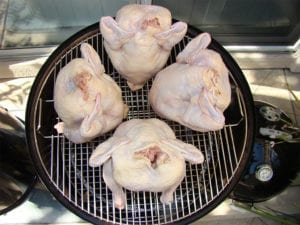 Overhead view of 4 beer can chickens on 22" top grate