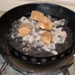 Smoke wood and hot coals in charcoal chamber