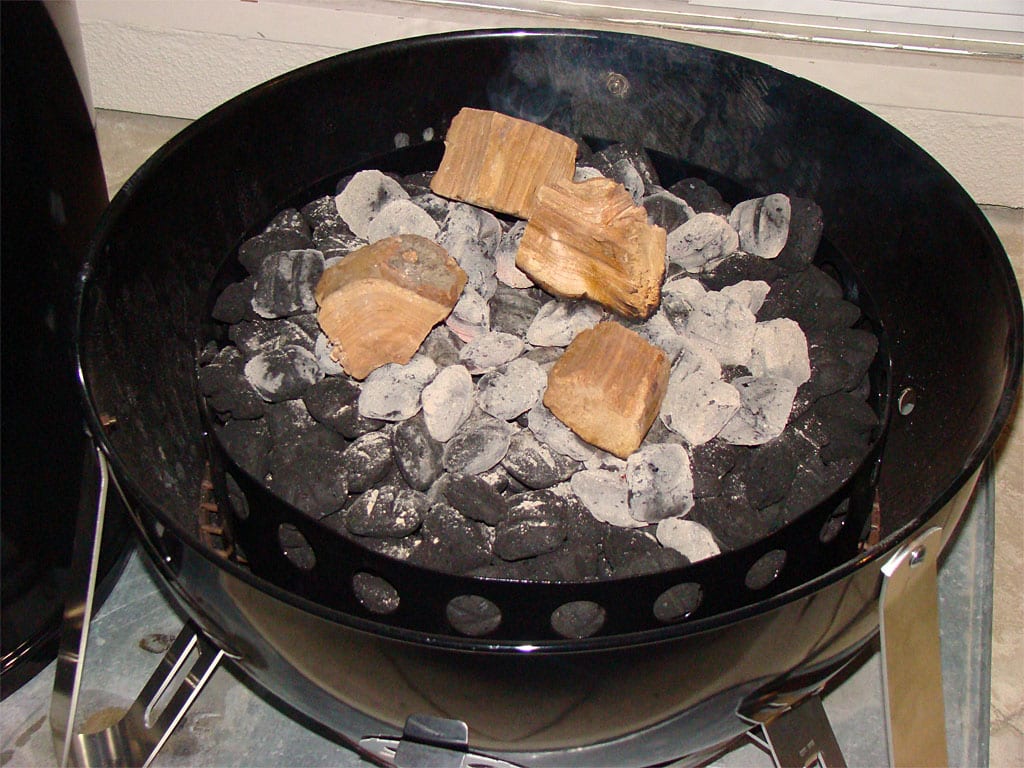 Smoke wood and hot coals in charcoal chamber