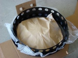 Charcoal ring and heat shield (in paper bag) sitting on water pan