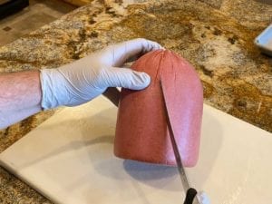Scoring the surface of the bologna