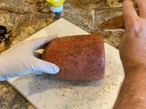 Applying rub to bologna