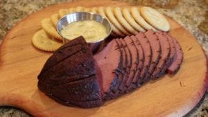 Slices of bologna with crackers and honey mustard