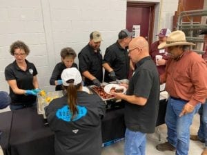 Hungry Camp Brisket students line up for brisket, sausage, sides and dessert