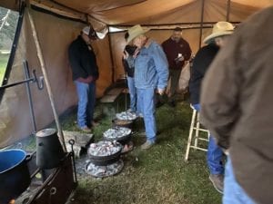 Homer Robertson supervising the Dutch ovens
