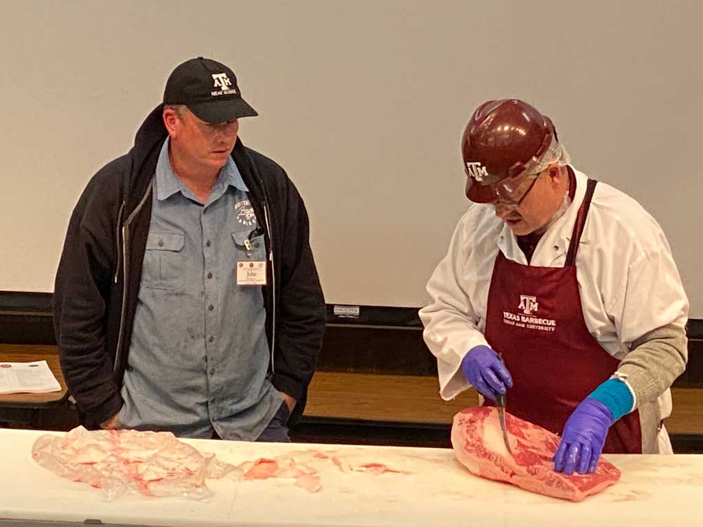 Dr. Davey Griffin trimming brisket with commentary from John Brotherton