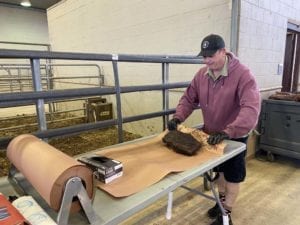 John Brotherton wrapping briskets in peach butcher paper