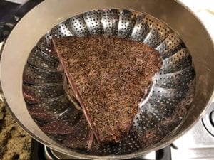 Steaming pastrami in Dutch oven