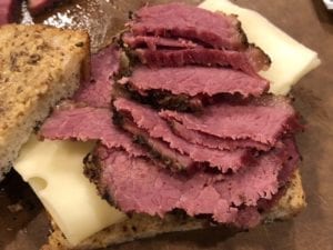 Sliced steamed pastrami on a sandwich