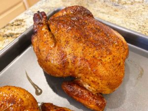 Close-up of peach-glazed Cornish game hen