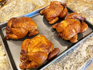 Cornish game hens on rimmed baking sheet