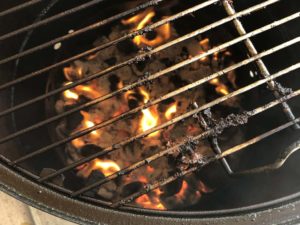 Pork fat burning in hot charcoal
