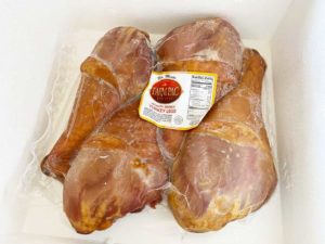 Four frozen giant Texas turkey legs in Cryovac bag