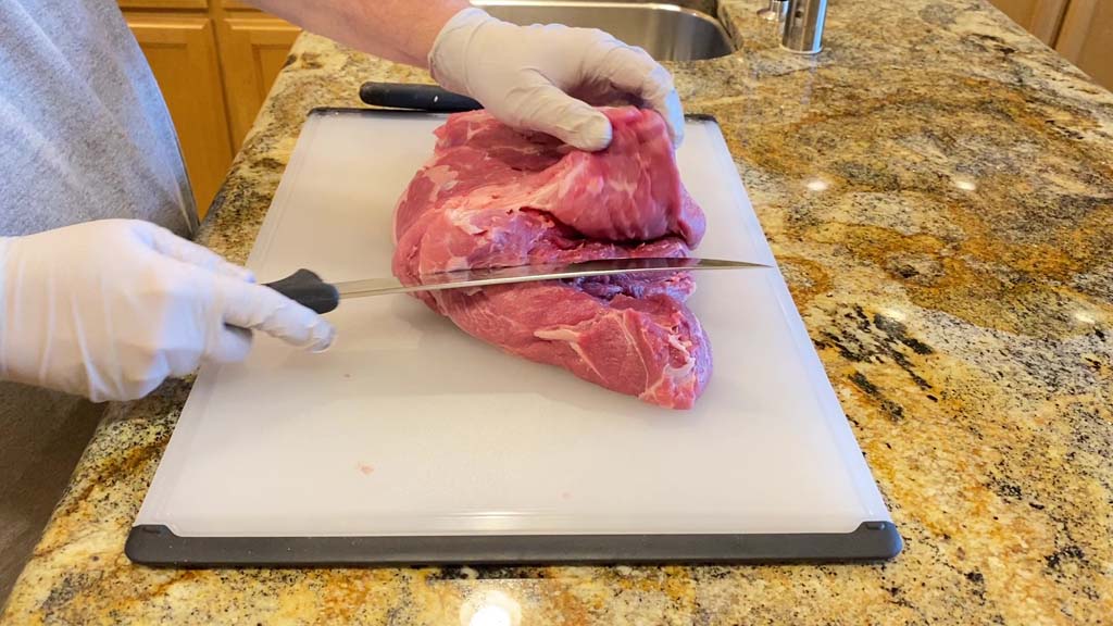 Cutting pork butt in half