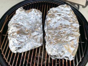Pork butt pieces wrapped in aluminum foil
