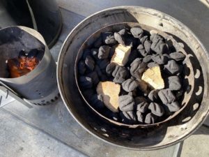 Smoke wood nestled into unlit charcoal