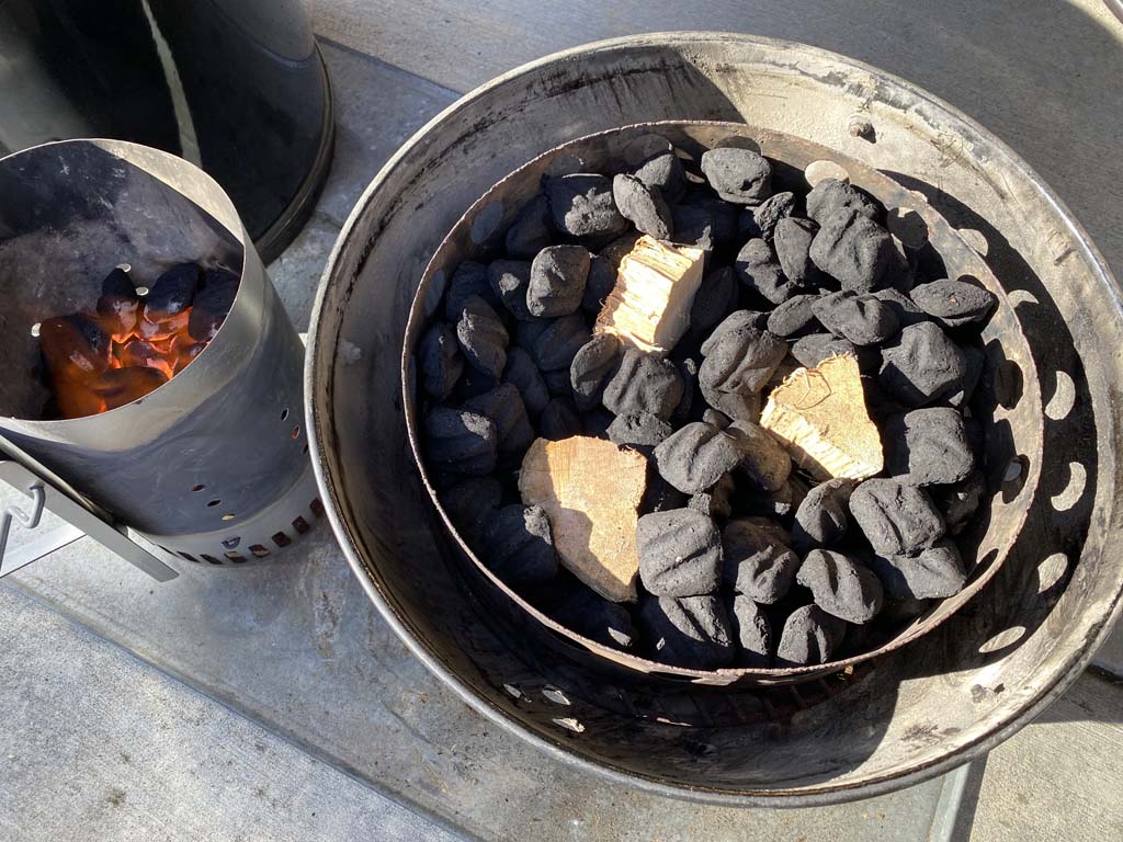 Smoke wood nestled into unlit charcoal