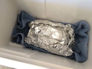 Foiled brisket in empty cooler