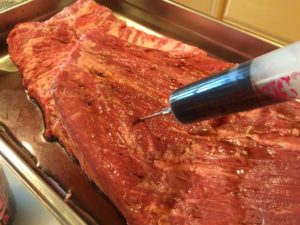 Injecting brisket with beef injection liquid
