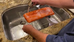 Rinsing cured salmon
