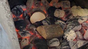 Smoke wood on top of hot charcoal