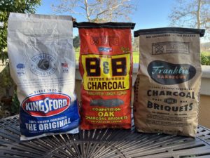 Bags of Kingsford Original, B&B Competition Oak, and Franklin Barbecue charcoal briquets